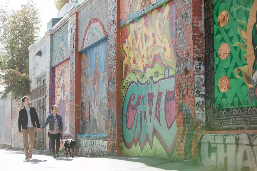 A couple walking down Balmy Alley in the Mission.