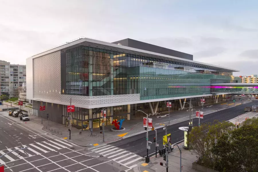 A wide shot of the glassy, modern Moscone Center South building.