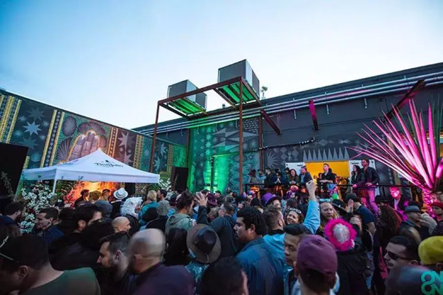 Exterior of a large crowd watching an open-air concert at The Midway.