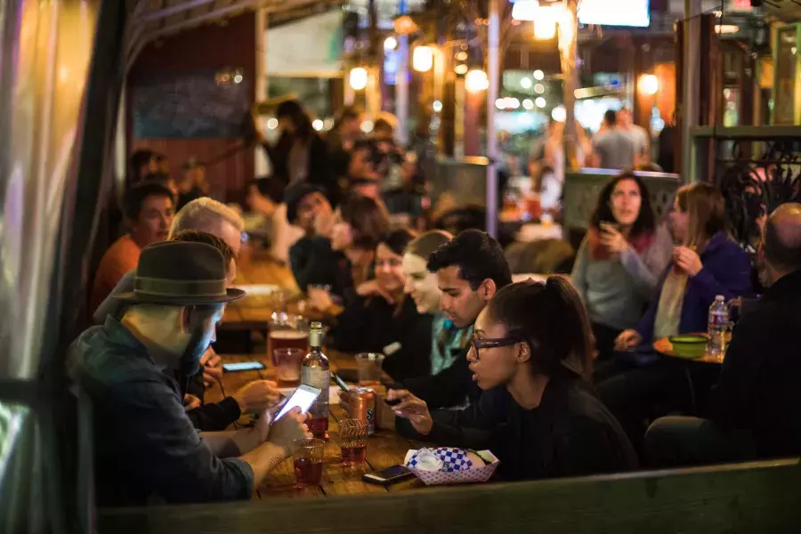 People eating in a crowded dining area in SoMa. San Francisco, California.