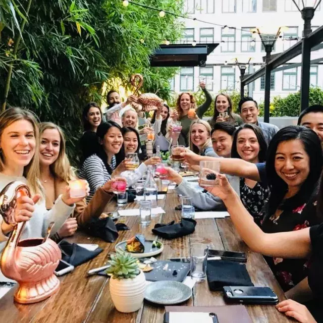 A group of people toasting at Dirty Habit